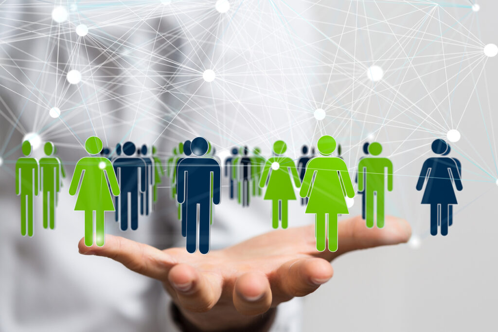 A 3D rendering of a group of floating people icons on a businessman's hand